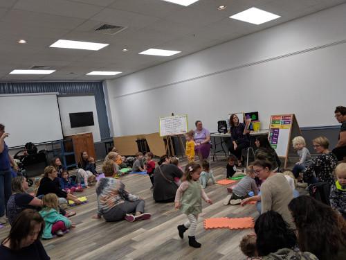 photo of a group of children and adults at storytime